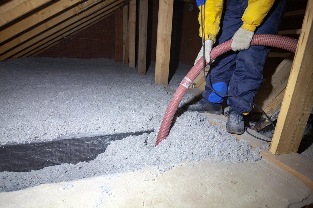 Man Installing Cellulose Insulation in an Attic