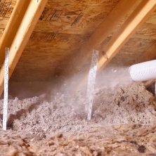 Machine blowing insulation onto an attic