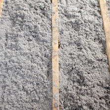 Gray cellulose insulation sitting in an attic
