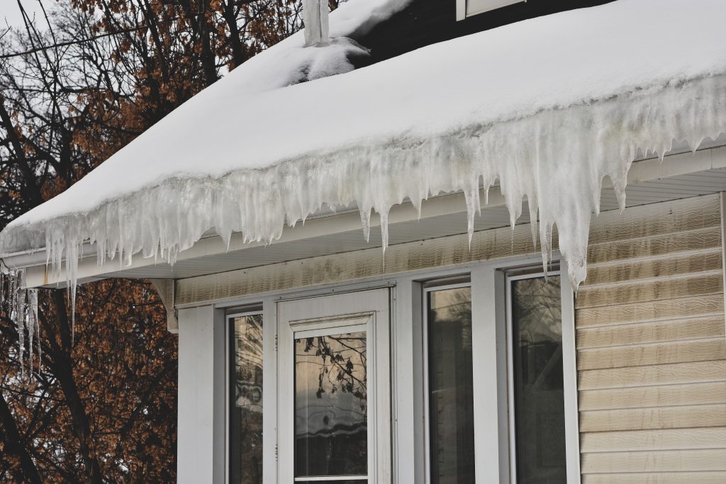 Melting snow and ice on a roof causing water damage